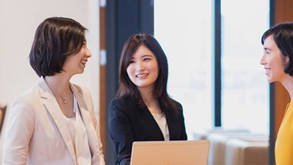 Three sales representatives are discussing the new products.