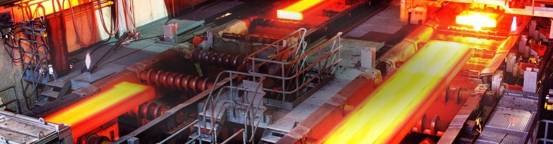 Many hydraulic oil and compressed air filter elements on steel plant background.